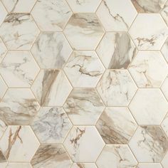 a white and brown marble tile with hexagonal design