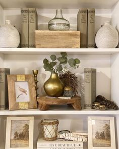 the shelves are filled with books and vases