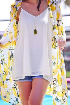 Major trend alert: LEMON PRINTS!  This kimono is bright, light, and sheer making it your go-to topper for the summer! It's perfect for throwing on over sundresses or just a simple tank with skinny jeans thanks to its effortless, flowy fit! Lemon Print Summer Tops, Flowy Top For Beach Cover-up In Spring, Lightweight Chic Spring Tops, Summer Vacation Tops With Lemon Print, Chic Lightweight Spring Tops, Lightweight Chic Tops For Spring, Chic Lightweight Tops For Spring, White Open Front Top For Summer, Chic Open Front Summer Tops