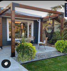 an outdoor patio with chairs and plants on the side walk, next to a house