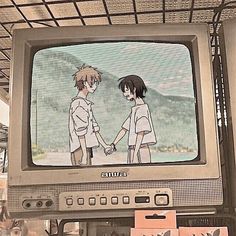 an old tv with anime characters on it