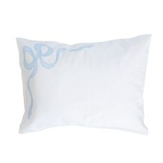 a white and blue pillow with an octopus on the front, sitting against a white background