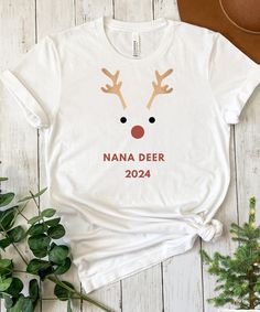 a white t - shirt with reindeer's face and the words nana deer on it