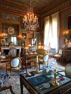 a living room filled with furniture and a chandelier