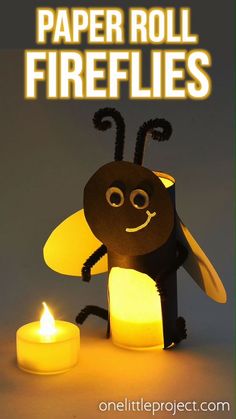 a paper roll firefly is sitting next to a lit candle with the words paper roll fireflies on it