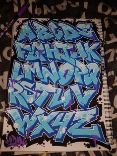 graffiti written on the side of a notebook