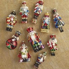 a group of christmas ornaments sitting on top of a wooden table next to each other