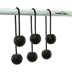 four black balls hanging from the end of a white pole with an ad for ladder ball on it