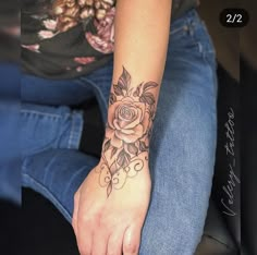 a woman with a rose tattoo on her arm