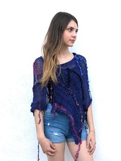 Loose Knit Boho Wrap. Fringe Mesh Knit Poncho Blue. Open Weave Knit Shawl This boho cotton blend hand-knitted fringed poncho in purple blue tones is light and airy. It is a four-season piece and is ideal for layering  The color palette is definitely jeans friendly.  STYLE This dressy/casual piece is an excellent travel companion.  Works well with jeans, leggings, swimsuit or over a solid dress adding a flowy elegance of a shawl. Endless in its versatility and fits most sizes make it a great gift One Size Blue Knit Sweater, Bohemian Shawl Knit Sweater, Bohemian Knit Shawl Sweater, Bohemian Shawl Sweater In Knit, One Size Knit Shawl Knitting Pattern, Bohemian Hand Knitted Shawl, Bohemian Hand-knitted Shawl, One Size Knit Poncho, Bohemian Knitting Pattern With Acrylic Yarn