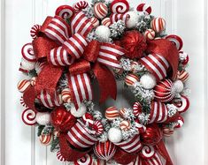 a red and white christmas wreath with candy canes