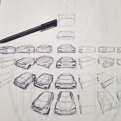 a drawing of several cars parked in a parking lot with a pen on the table