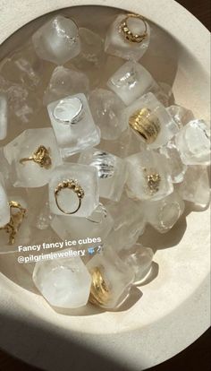 ice cubes and gold rings in a bowl