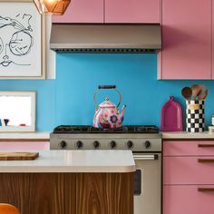 a tea kettle sitting on top of a stove in a kitchen