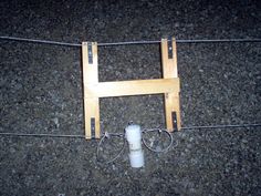 an electric fence with two wires attached to it on the ground next to a pole