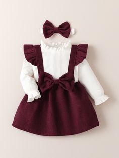 Dress Your Baby Girl in Adorable Autumn Style with our 3-Piece Ruffle Burgundy Corduroy Bow Suspender Dress Set - The Perfect Outfit for Fall and Winter!" 🍂👶❄️Elevate her look with this charming ensemble, featuring a ruffle burgundy corduroy suspender dress adorned with a cute bow, paired with a cozy top and matching tights. Crafted with attention to detail, this set is perfect for the autumn, fall, and winter seasons, making your baby girl look absolutely adorable. Whether it's for outings, g Burgundy Baby Dress, Newborn Winter Dress, Burgundy And Cream Family Pictures, Christmas Minis Outfits, Winter Baby Dress, Baby Holiday Outfits, Infant Christmas Outfit, Baby Winter Outfits