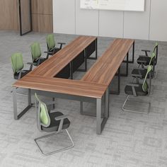 an empty conference room with green chairs and a wooden table