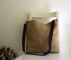 "An everyday bag, simple basic PERFECT lightweight bag. You can wear it as a shoulder short strap bag or with a long strap as a messenger. Great for carrying anything for the day. The exterior is rough upholstery canvas. The bag is lined and has two inside pockets, one is designed for a cell phone. The adjustable strap is genuine leather. The bag closes with a magnetic snap. Measurements: Shoulder strap: 18\" ( 45 cm) Messenger: 36\" ( 90 cm) Height: 14\" ( 35 cm) Width at the top: 15\" ( 37.5 c Lightweight Bag, Strap Bag, A Cell, Brown Leather Strap, Everyday Bag, Bag Straps, Inside Pocket, Diaper Bag, Messenger Bag