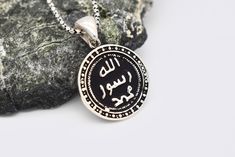 Silver Allah Name Necklace ✔Handmade Islamic necklace ✔925 sterling silver ✔Preserves its shine for a long time ✔Ready for shipping Material: 925 Sterling Silver You may choose it as a gift for him.🤍 If you have a question please don't hesitate to contact me. YOU MAY USE THE EXPRESS SHIPPING OPTION TO GET YOUR ORDER FASTER. Express shipping send by UPS, TNT, and FedEx. Delivery time: *Europe 2-4 business days, *USA- Canada 3-7 business days, *Everywhere else 5-10 business days. **Please share y Traditional Round Jewelry For Commemoration, Spiritual Sterling Silver Coin Pendant Jewelry, Sterling Silver Spiritual Coin Pendant Jewelry, Traditional Pendant Jewelry For Commemoration, Traditional Sterling Silver Coin Pendant Jewelry, Traditional Sterling Silver Coin Necklaces, Traditional Sterling Silver Jewelry With Coin Pendant, Sterling Silver Medallion Jewelry For Gift, Symbolic Coin-shaped Sterling Silver Jewelry