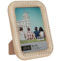 a wooden frame with an image of people sitting on the grass in front of a building