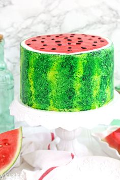 a watermelon cake with black dots on top