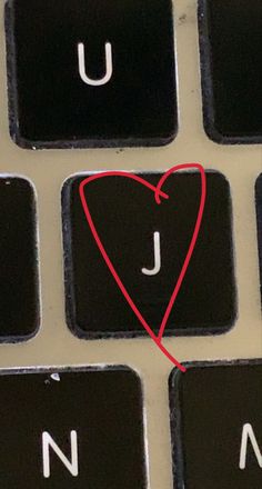 a keyboard with a heart drawn on it's keys and the letter j in red