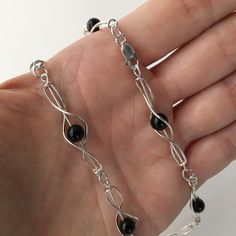 "Each link of this sterling silver chain is constructed by hand. The 6mm onyx bead can move freely in the link. Each link is approximately 1 1/2\" long. The necklace is 16\" long and has a sterling silver lobster claw clasp. If you would like a different length, please let me know, I would be happy to make it for you. I can also make this necklace with a different type of stone bead. The necklace will be shipped in a decorative cardboard jewelry box filled with anti-tarnish cotton. Sterling silv Cardboard Jewelry, Hammered Bangles, Small Gold Hoops, Cardboard Jewelry Boxes, Heart Choker, Onyx Necklace, Silver Heart Necklace, Onyx Bead, Black Necklace