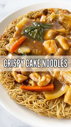 crispy cake noodles with chicken and vegetables on a white plate text reads crispy cake noodles