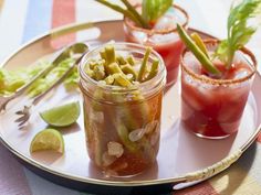 three jars filled with food sitting on top of a plate