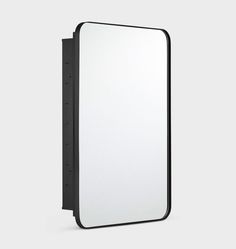 a black and white mirror on the wall