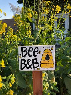 a bee b & b sign in front of yellow flowers