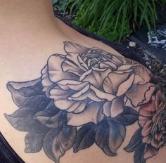 a woman's shoulder with flowers on it