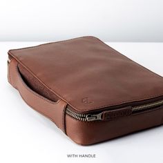 a brown leather pouch sitting on top of a white table