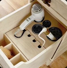 an electric hair dryer sits in a drawer