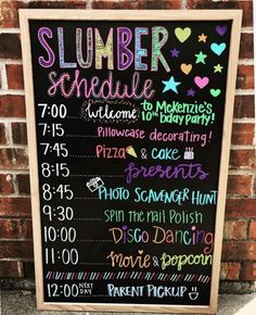 a chalkboard sign that says slumber schedule on the side of a brick wall