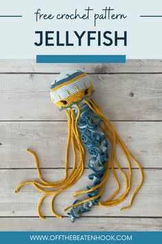 a jellyfish made out of crochet and yarn with text overlay that reads free crochet pattern jellyfish