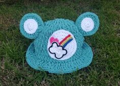 a crocheted teddy bear hat with a rainbow on it