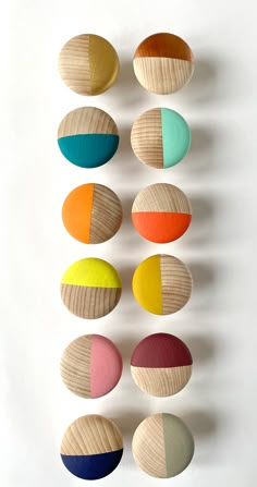 six wooden circles with different colors in them on a white surface, one is made from wood and the other is painted multicolored