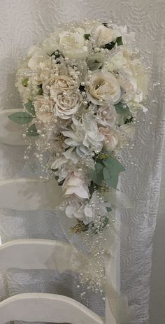 a bouquet of flowers sitting on top of a white chair