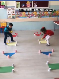 two children playing with blocks in a classroom