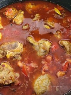 a pot filled with stew and meat in it's broth, ready to be cooked