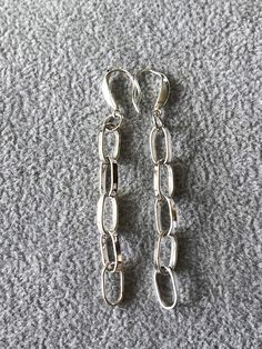 Made by hand using 16 gauge 925 silver wire rolled through a rolling mill, hand shaped, soldered into oval links (almost 1/2" long and 1/4" wide) and assembled into a strip of paperclip style chain. Short modern style hook were added.  Polished finish. Total drop is 3" Made to order so please allow few days for manufacturing process. Sterling Silver Chain Dangle Earrings, Modern Silver Paperclip Jewelry, Silver Dangle Jewelry With Paperclip Chain, Formal Sterling Silver Chain Earrings, Silver Link Sterling Silver Earrings, Silver Sterling Link Earrings, Silver Metal Paperclip Earrings, Formal Nickel-free Silver Linear Earrings, Silver Long Drop Earrings With Chain