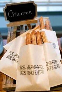 several baguettes sitting on top of a wooden crate next to a chalk board