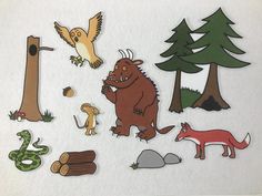 an assortment of stickers with animals and trees on white paper, including a bird