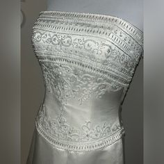 a white wedding dress on display in a museum