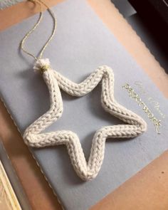 a crocheted star ornament hanging from a book