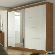 an empty room with a large mirror on the wall and sliding doors in front of it