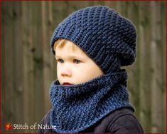 a little boy wearing a knitted hat and scarf with a hood on his head