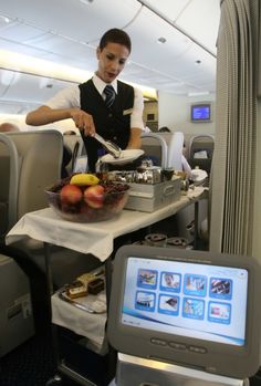 a man is serving food on an airplane