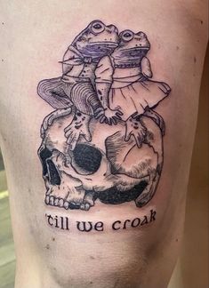 a tattoo on the side of a man's leg with an image of two frogs riding